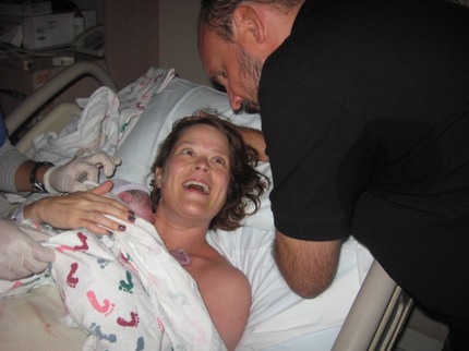 Newborn with happy mom and dad in hospital